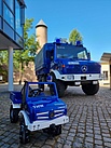 Spielzeug Unimog vor echtem Unimog vor dem Burgturm Nohfelden.